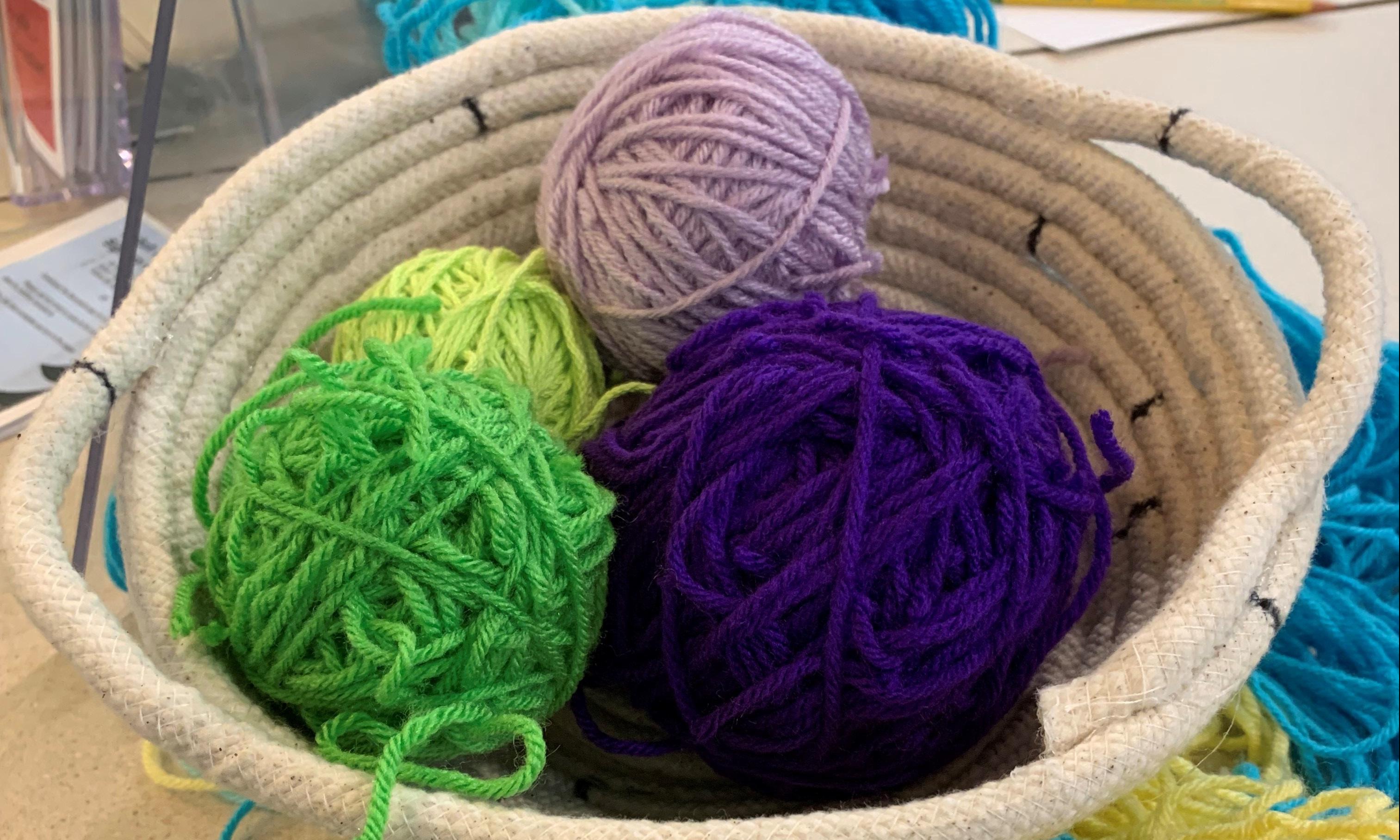 rope basket with yarn balls in it